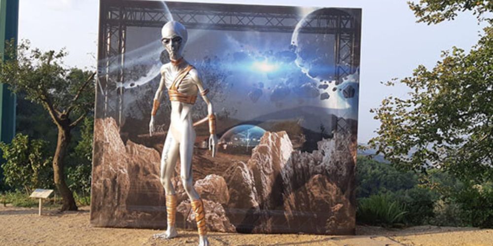 An image of a 3d printed alien standing in front of a galactic background