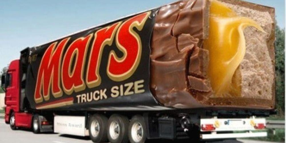 A large truck with a Mars bar design: the entire back of the truck appears to look like a huge, realistic looking candy bar and wrapper