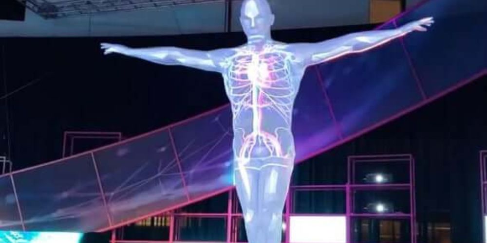 An example of a 3D image mapping display featuring a translucent person stretching out their arms with inner anatomy visible