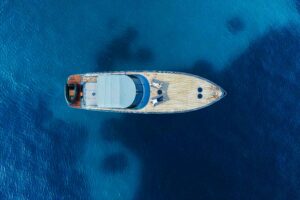 An aerial view of a yacht surrounded by the sea